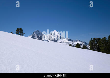 perfectly white snow slope partly covering moutains in the background, Bavaria, Germany Stock Photo