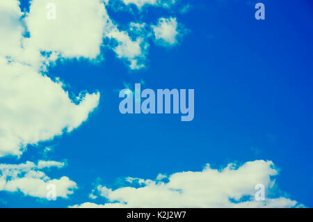 Sky and clouds. Retro style filtered image. Bright blue sky with white clouds bokus with place for text Stock Photo