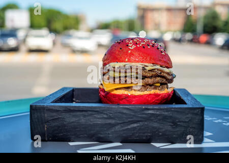 Restaurant burger with red bun on wooden board Stock Photo