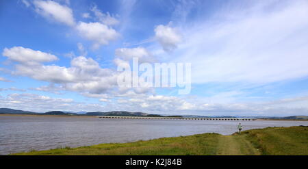 Lone walker on the Riverbank near Arnside Lancashire. Stock Photo