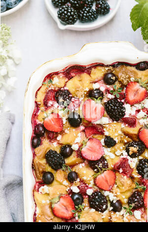 A goat cheese & berry bread pudding is photographed from the top after it was baked. Stock Photo