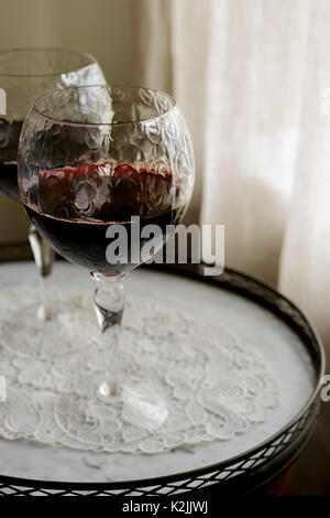 Two glasses of red wine on a table Stock Photo