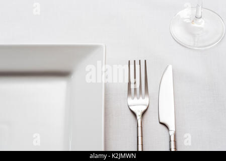 Single place table setting, knife fork plate. Stock Photo
