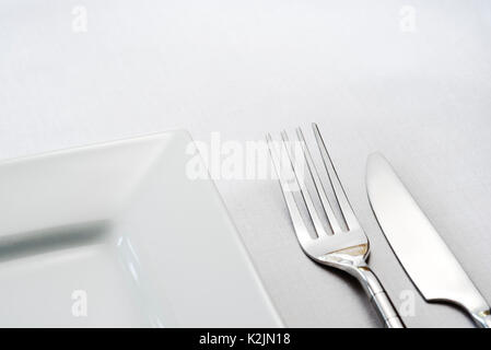 Single place table setting, knife fork plate. Stock Photo