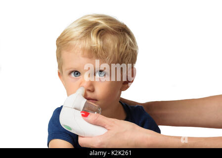 Mother using baby electric nasal aspirator. She is doing a mucus suction to twenty months baby boy,white backgrounds. Stock Photo