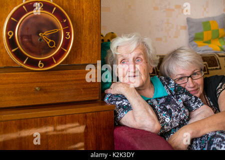 Elderly woman in home with his adult daughter. Stock Photo