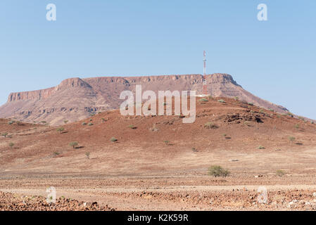 A cellphone tower on a hill in the arid semi-desert landscape at Bergsig, a small village in the Kunene Region of Namibia Stock Photo