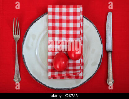 Easter eggs on a plate on red background Stock Photo