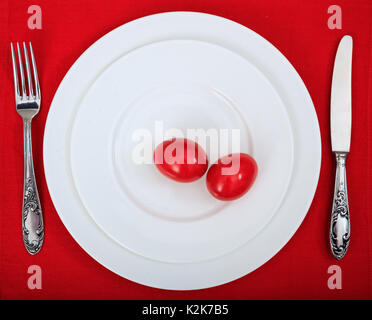 Easter eggs on a plate on red background Stock Photo