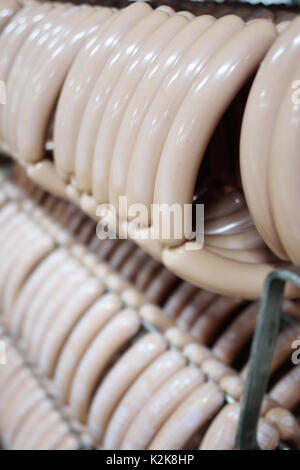 mouthwatering smoked sausages on the background of a meat factory Stock Photo