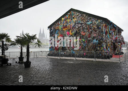Cologne, Germany. 31st Aug, 2017. The 'Save The World' Hotel by performance artist HA Schult can be seen at the Rhine river in Cologne, Germany, 31 August 2017. The sculpture is an accessible house made of and decorated with trash. Photo: Henning Kaiser/dpa/Alamy Live News Stock Photo