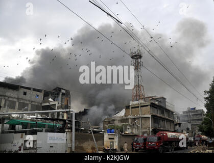 Karachi. 1st Sep, 2017. Photo taken on Sept. 1, 2017 shows smoke rising from the fire site in south Pakistani port city of Karachi. At least five people including three firefighters were injured as a shoe factory caught fire in SITE area of Karachi on early Friday morning, local media reported. Credit: Masroor/Xinhua/Alamy Live News Stock Photo