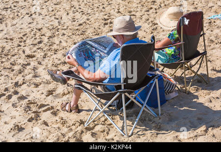 Bournemouth, Dorset, UK. 1st Sep, 2017. UK weather: lovely warm sunny day at Bournemouth beach on the South Coast. Senior couple sitting in chairs, man reading the Daily Mail newspaper. Credit: Carolyn Jenkins/Alamy Live News Stock Photo