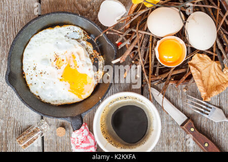 autumn breakfast in nature, coffee and fried egg Stock Photo