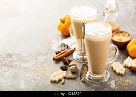 Pumpkin spice latte in tall mugs with cinnamon, nutmeg and cardamom Stock Photo