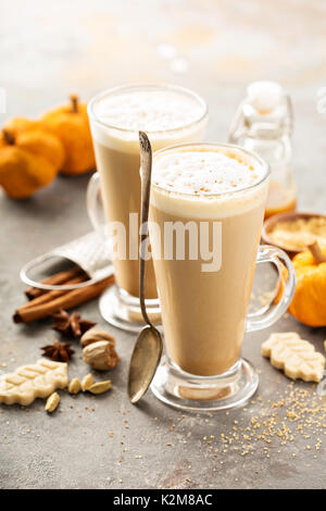 Pumpkin spice latte in tall mugs with cinnamon, nutmeg and cardamom Stock Photo