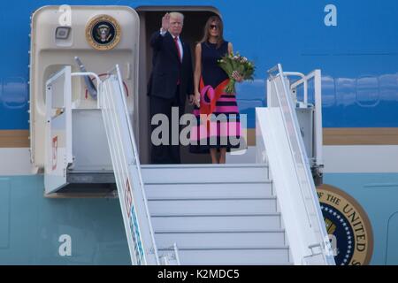 U.S. President Donald Trump and First Lady Melania Trump wave as they board Air Force One after a visit to Warsaw July 6, 2017 in Warsaw, Poland. Stock Photo