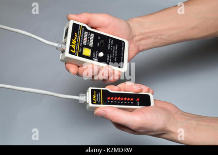 Hand of the master LAN check tester for crimped wire for compute Stock Photo