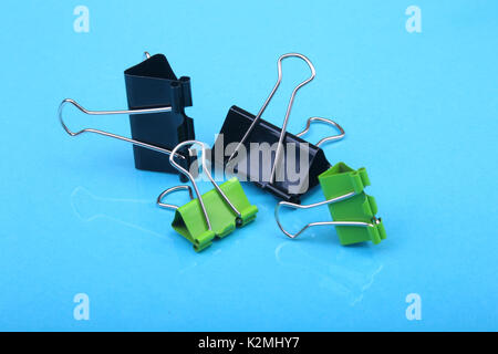 Close-up with Set of color clerical clips for paper on blue background Stock Photo