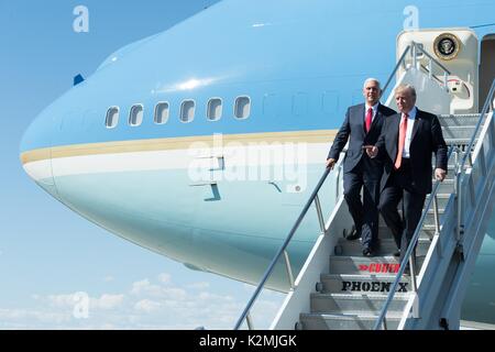 U.S. President Donald Trump and Vice President Mike Pence walk down the stairs from Air Force One on arrival for a rally August 22, 2017 in Phoenix, Arizona. Stock Photo
