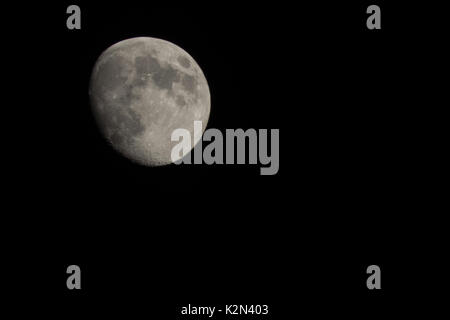 Close-up of the moon shot on a clear sky night in July. Stock Photo