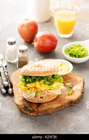 Breakfast bagel with scrambled eggs, turkey and cheese Stock Photo