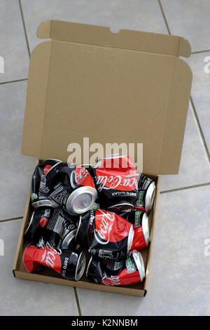 crumpled cola cans in a cardbord box Stock Photo