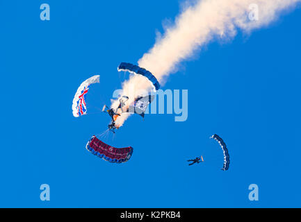 Bournemouth, UK. 31st Aug, 2017. The Tigers Freefall Parachute Team open the tenth anniversary of the Bournemouth Air Festival ahead of the flying later this afternoon. 4 Four parachutists with their parachutes canopies - Army Be The Best against blue sky. Credit: Carolyn Jenkins/Alamy Live News Stock Photo