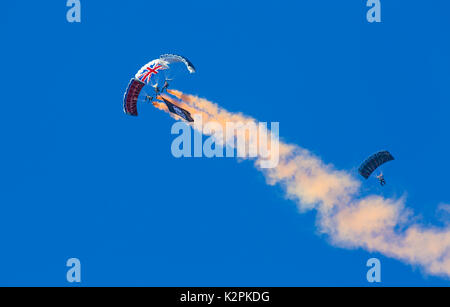 Bournemouth, UK. 31st Aug, 2017. The Tigers Freefall Parachute Team open the tenth anniversary of the Bournemouth Air Festival ahead of the flying later this afternoon. 4 Four parachutists with their parachutes canopies against blue sky. Credit: Carolyn Jenkins/Alamy Live News Stock Photo