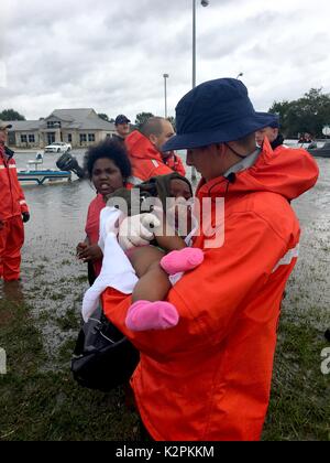 Port Arthur, United States. 30th Aug, 2017. U.S. Coast Guard Petty Officer 3rd Class Ryan Hicks rescues a child from flooding in the aftermath of Hurricane Harvey August 30, 2017 in Port Arthur, Texas. Credit: Planetpix/Alamy Live News Stock Photo