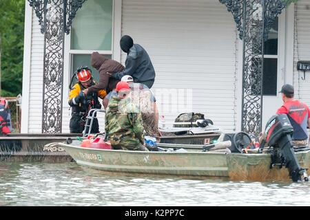 Port Arthur, United States. 30th Aug, 2017. Texas National Guard Rescue Specialists assist volunteers from the Cajun Navy in evacuating elderly residents stranded residents in the aftermath of Hurricane Harvey August 30, 2017 in Port Arthur, Texas. Credit: Planetpix/Alamy Live News Stock Photo