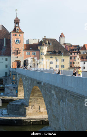 Crossing the Danube (Donau) on a restored section of the Stone Bridge or Steinerne Bruecke at Regensburg, Bavaria, Germany Stock Photo