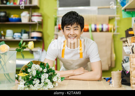 Portrait of smiling flower shop owner working. Small business. Stock Photo