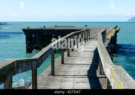 Old wooden wharf, Hicks Bay, Ohiwa, near Opotiki, Bay Of Plenty, North Island, New Zealand Stock Photo