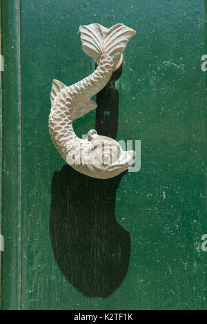 Close-up view of the fish shaped knocker on a green wooden door. Valetta, Malta Stock Photo
