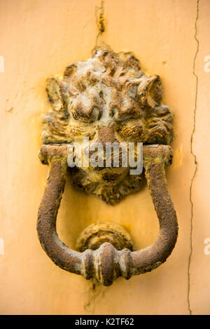 Close-up view of ancient rusty lion head shaped knocker. Mdina, Malta Stock Photo