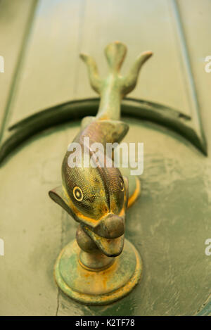 Close-up view of the fish shaped knocker on a green wooden door. Mdina, Malta Stock Photo