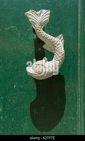 Close-up view of the fish shaped knocker on a green wooden door. Valetta, Malta Stock Photo