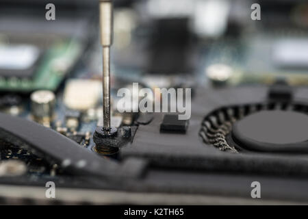 Close-up Of Person Hands In Glove Repairing Laptop Motherboard Stock Photo