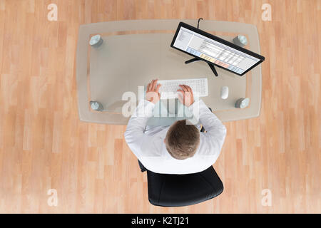 High Angle View Of Doctor Working On Computer In Clinic Stock Photo