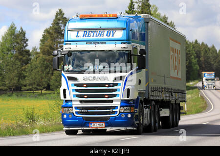 SALO, FINLAND - JUNE 11, 2017: Two beautifully customized Scania R500 semi trucks of L Retva Oy transport goods along summer highway. Stock Photo