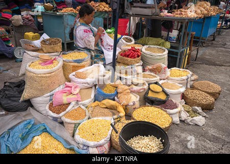 May 6, 2017 Otavalo, Ecuador: produce vendor in the Saturday market selling from street level Stock Photo