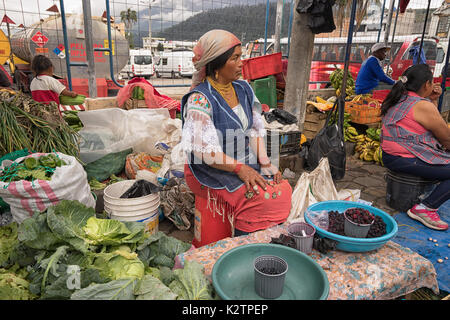 May 6, 2017 Otavalo, Ecuador: produce vendor in the Saturday market selling from street level Stock Photo