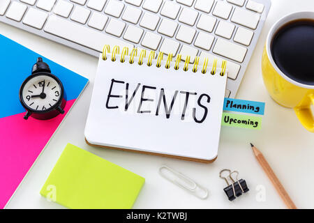 Events word on notebook with clock notepad on computer desk for event planning concept Stock Photo