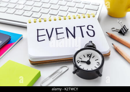 Events word on notebook with clock notepad on computer desk for event planning concept Stock Photo