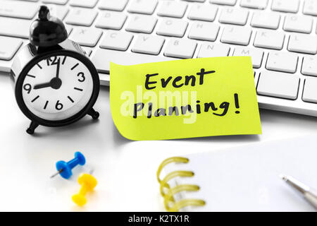 Event planning word on notepad with clock on white computer desk Stock Photo