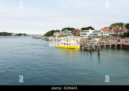 Brownsea Island ferry boat stopped at jetty to pick up / drop off passengers at the end of the Sandbanks peninsular, Poole, Poole Harbour, Dorset, UK Stock Photo