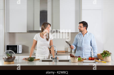 couple preparing food in a kitchen Stock Photo