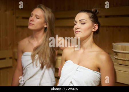 Two friends relaxing in sauna Stock Photo