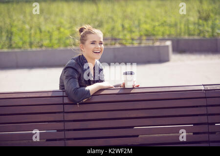 Joyful young woman having coffee break Stock Photo